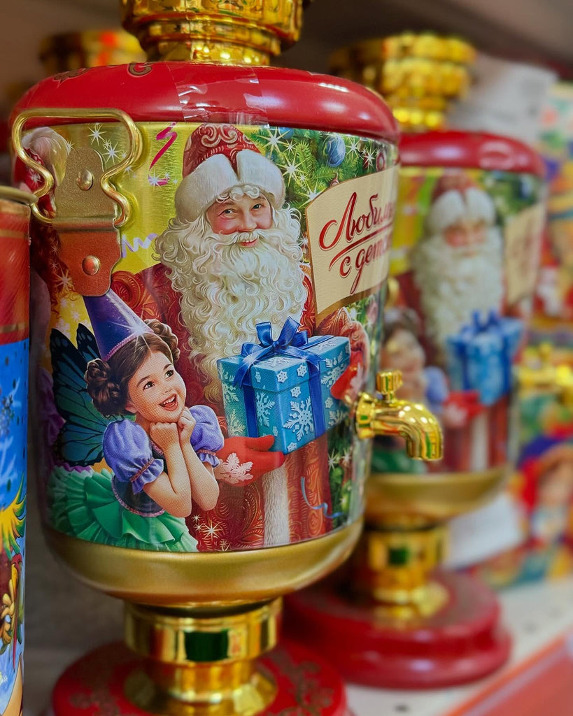 Decorative water dispenser with Santa Claus and child illustration, surrounded by similar items.
